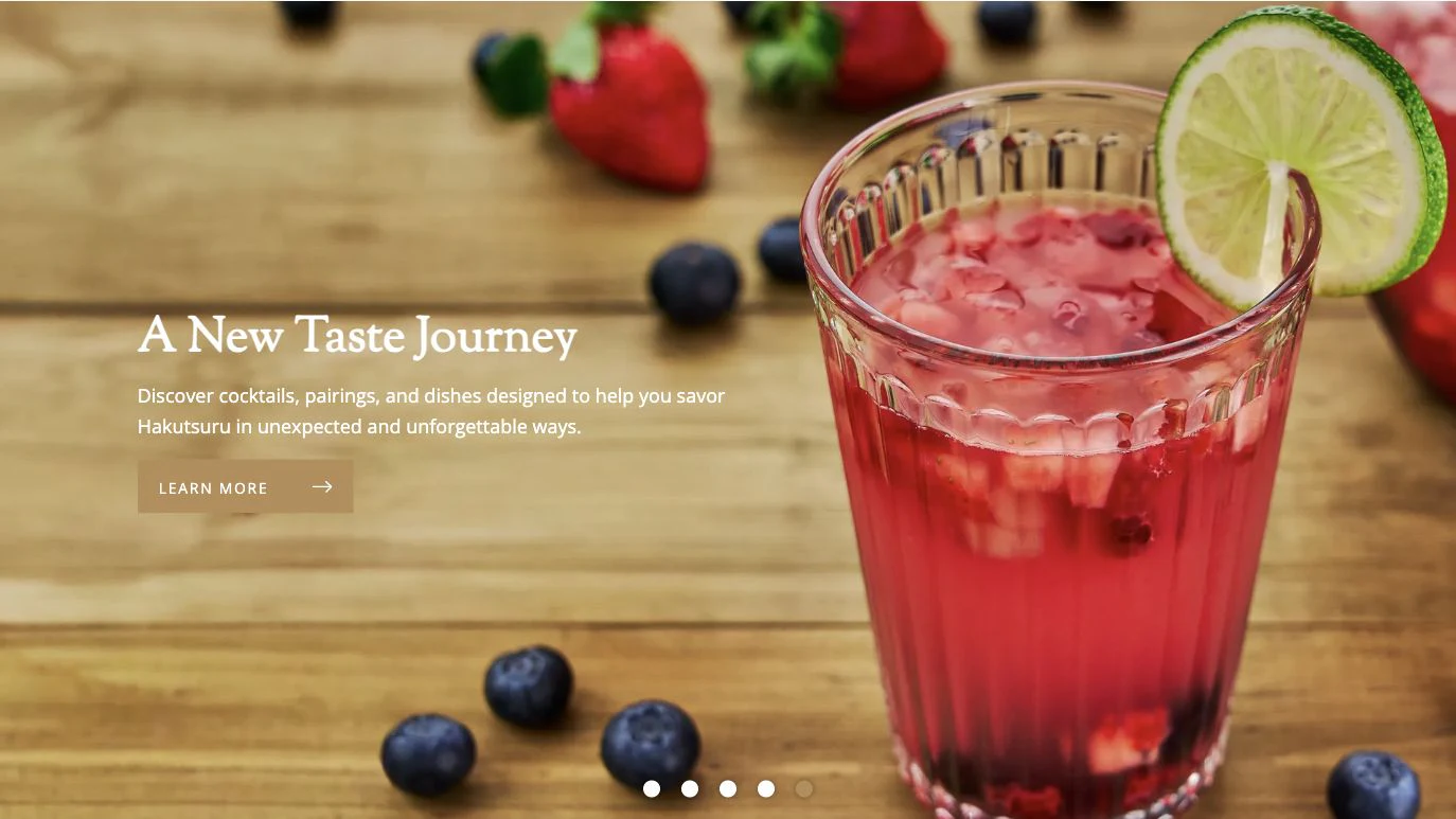 Hakutsuru homepage hero showing a vivid red sake cocktail with berries and lime