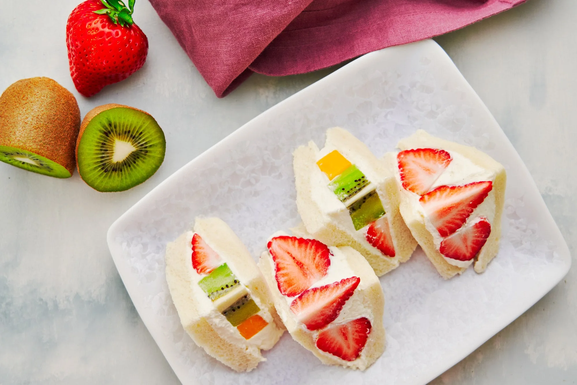 Japanese fruit sandwiches filled with strawberries, kiwi, orange, and cream